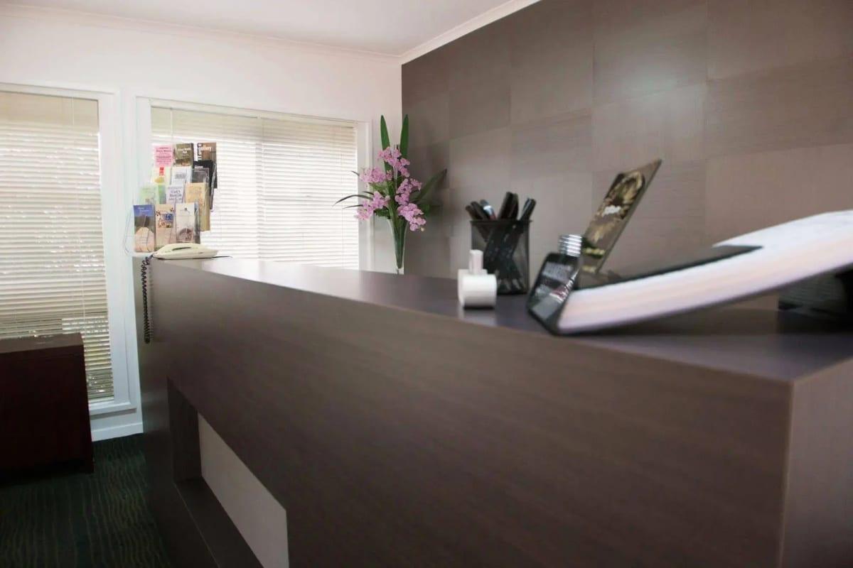 The reception desk with orchids, local brochures and breakfast menus