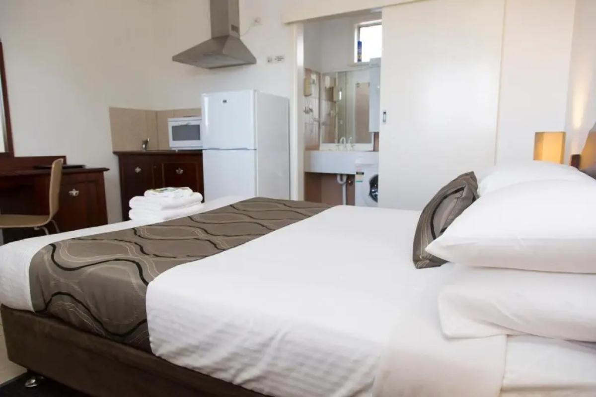 Studio room with queen bed, kitchenette and full-size fridge