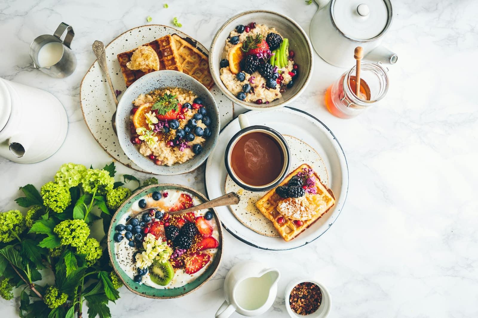 Breakfast spread with coffee, fruit and waffles
