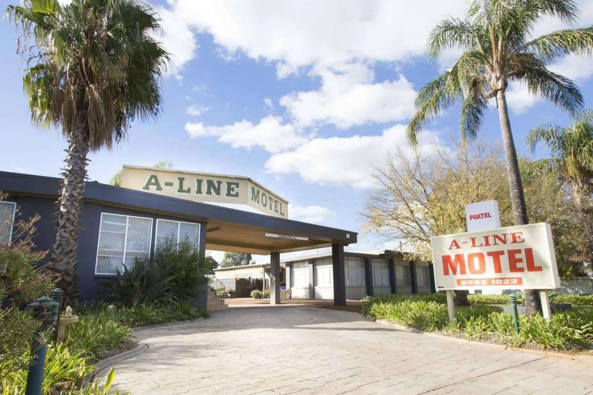 The A-Line Motel entrance and signage framed by palm trees